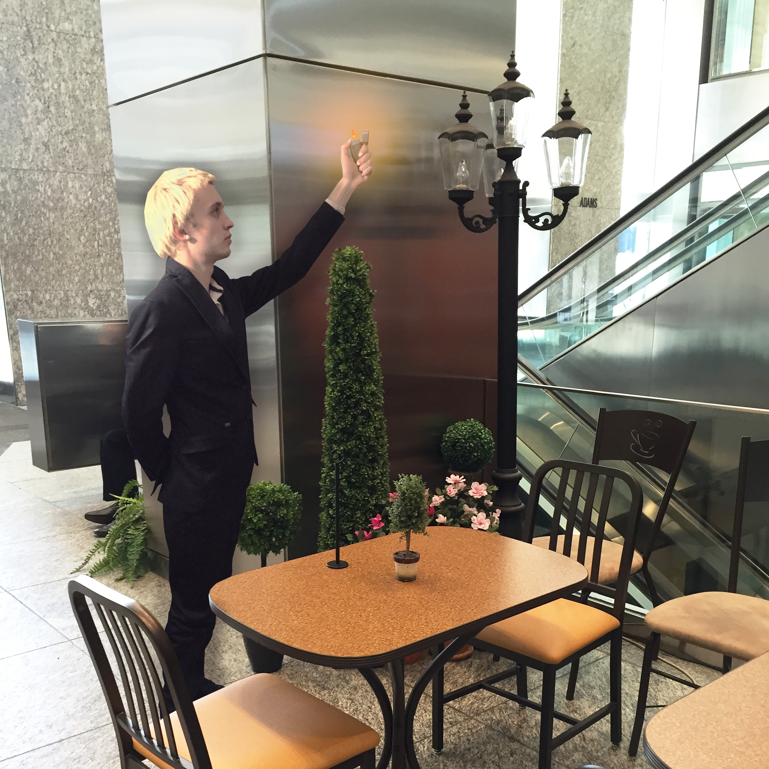 Butler lighting a lamp in a food court with a lighter